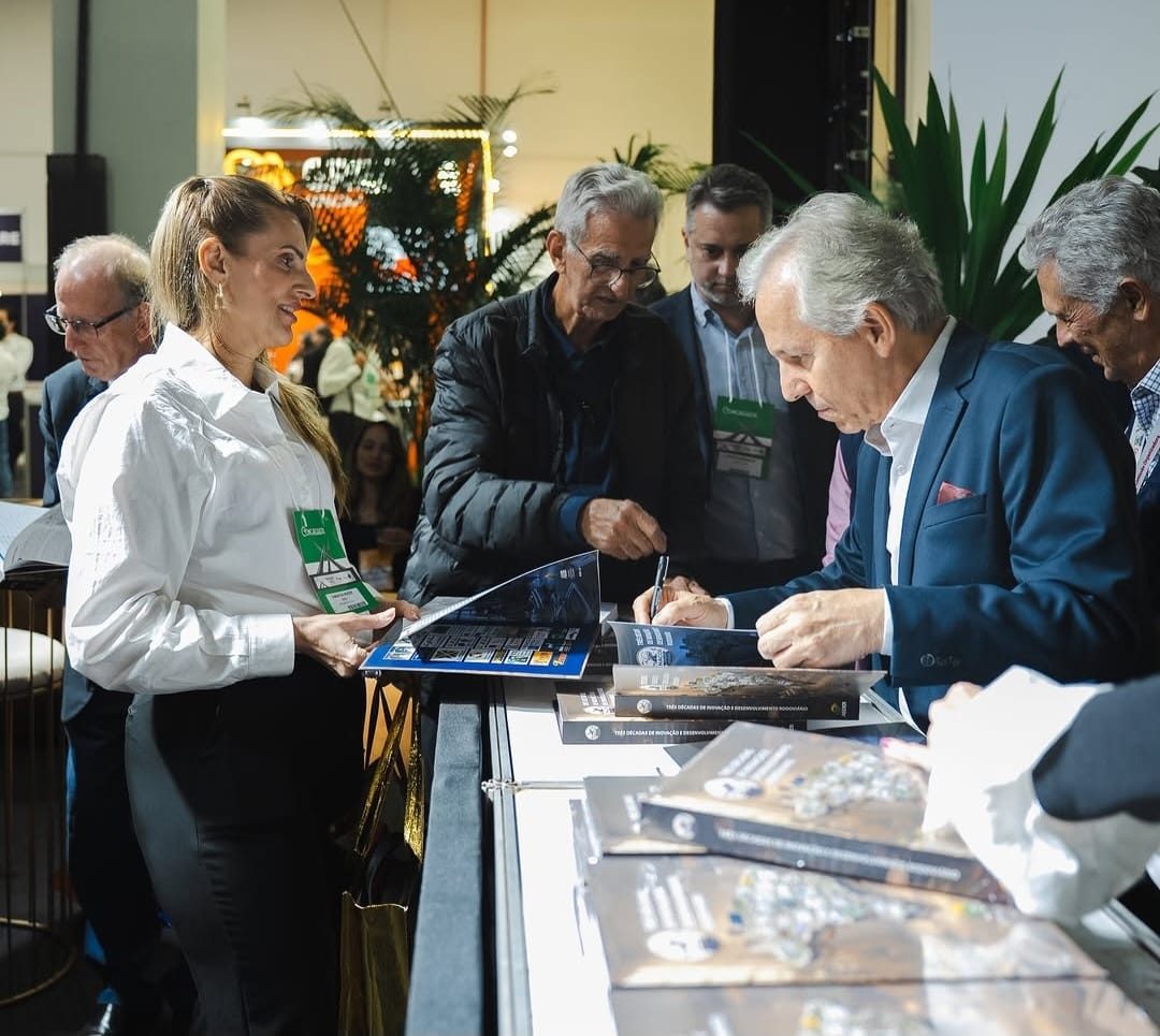 Sessão de assinatura do livro dos 30 anos do ENACOR na área de exposições